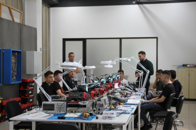 Students in the midst of an electronics workshop.