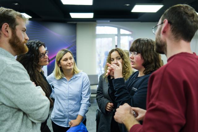 Youngsters explaining ideas to mentors during hackathon