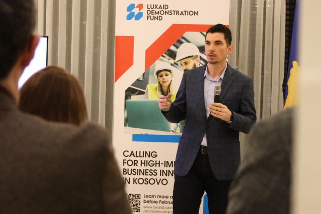 LuxDev Agon Dula presenting LuxAid Demonstration Fund to businesses