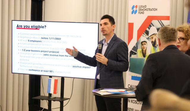LuxDev Agon Dula presenting LuxAid Demonstration Fund to business community