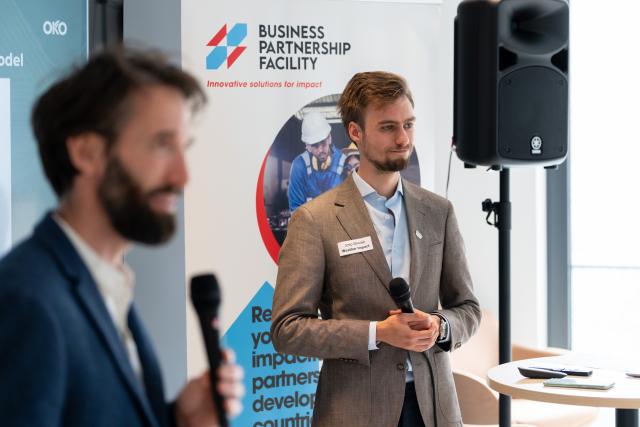 two persons pitching in front of an audience