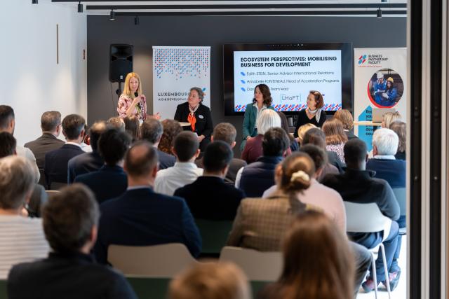 4 women in a panel discussion in front of an audience